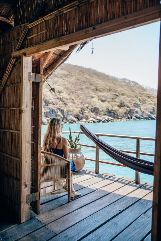 Sustainable Luxury Travel: Eco-Friendly High-End Tourism 3 Woman sitting by waterside